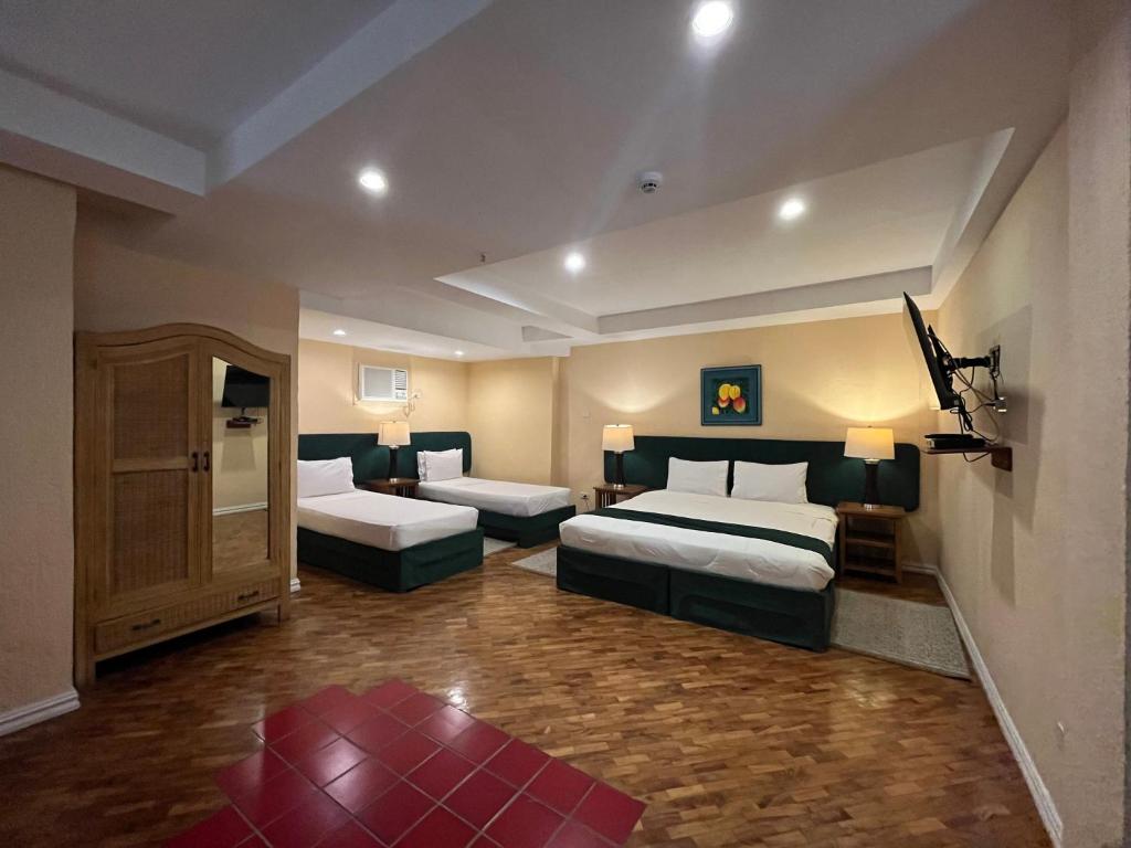 Postel nebo postele na pokoji v ubytování Coco Grande Hotel