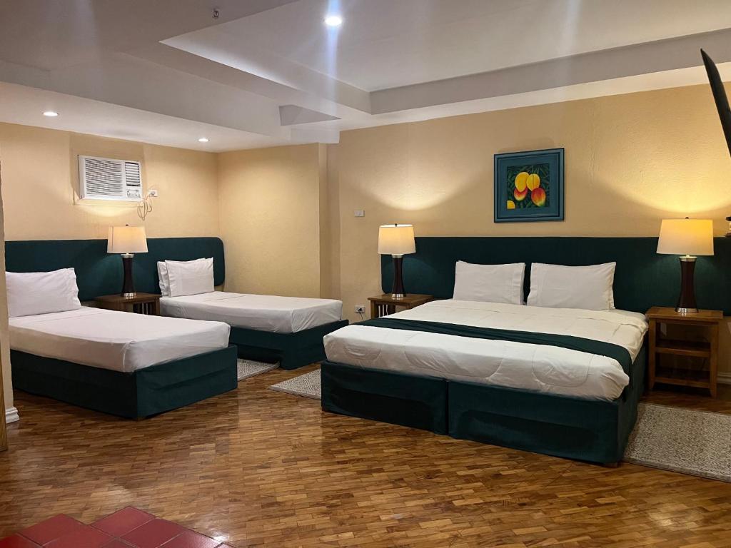 Postel nebo postele na pokoji v ubytování Coco Grande Hotel
