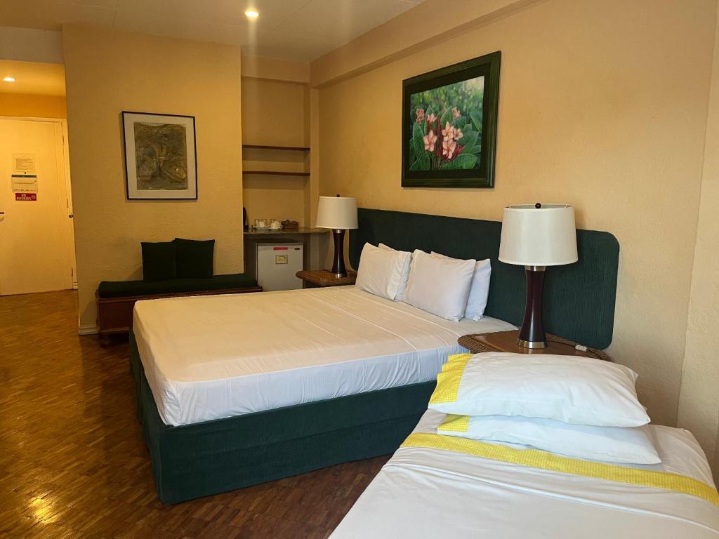 Postel nebo postele na pokoji v ubytování Coco Grande Hotel