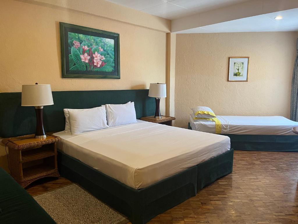Postel nebo postele na pokoji v ubytování Coco Grande Hotel