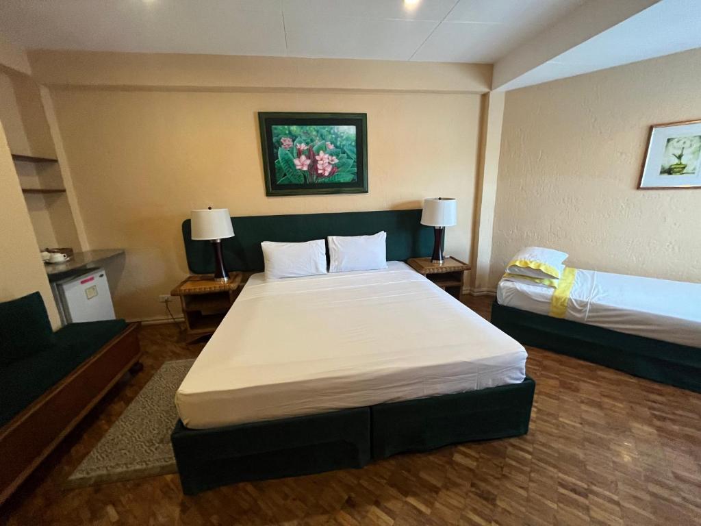 Postel nebo postele na pokoji v ubytování Coco Grande Hotel