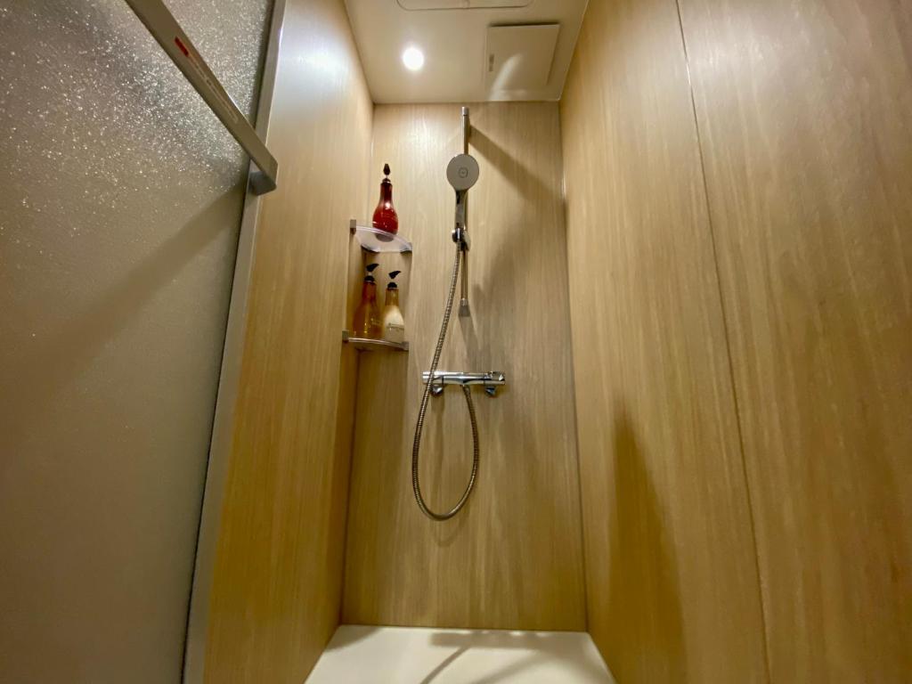 a bathroom with a shower with a shower head at Villa Monica in Nagoya