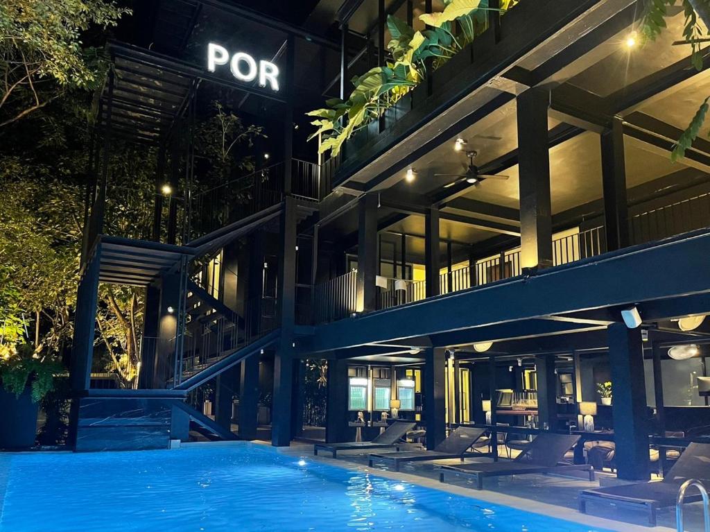A wide evening view of the pool courtyard and open-sided hotel facilities.