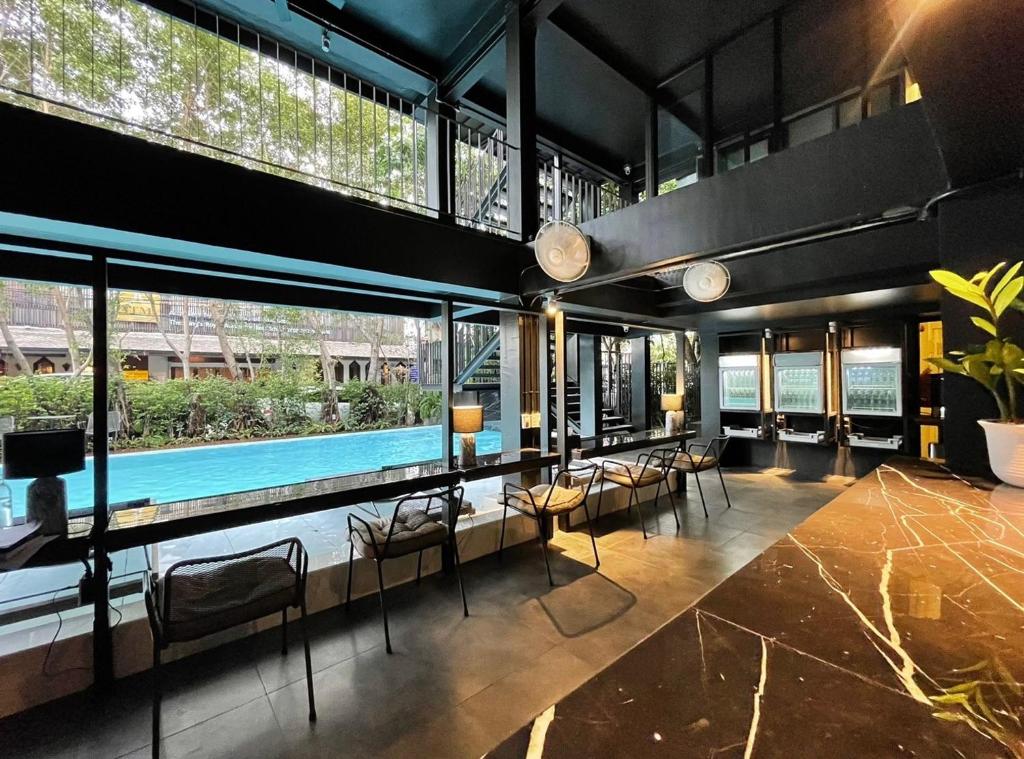 A dark, modern lounge beside the outdoor pool.