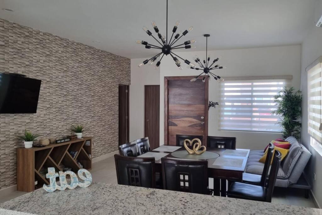 a living room with a table and a dining room at Casa Mauricio in La Paz