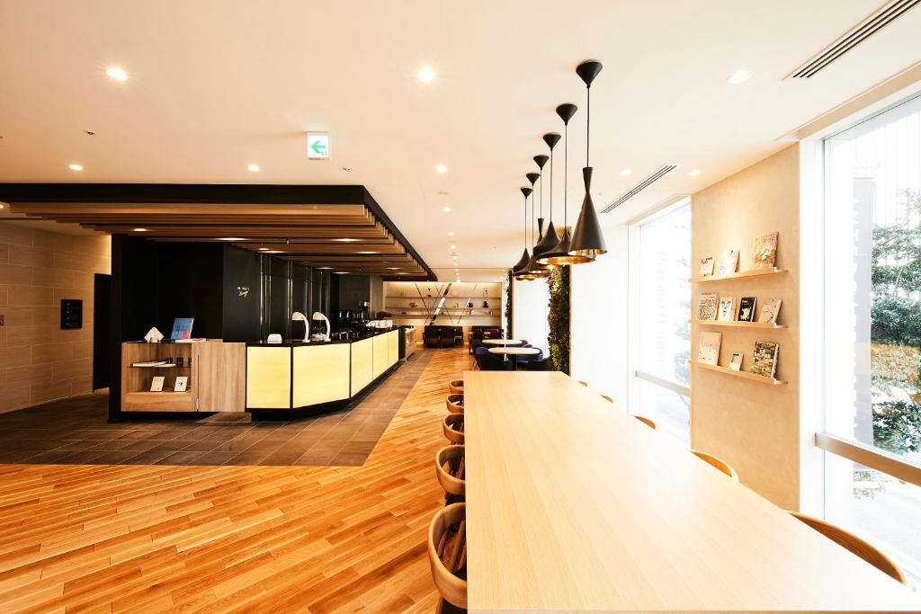 a dining room with a long table in a room at Hotel Intergate Tokyo Kyobashi in Tokyo