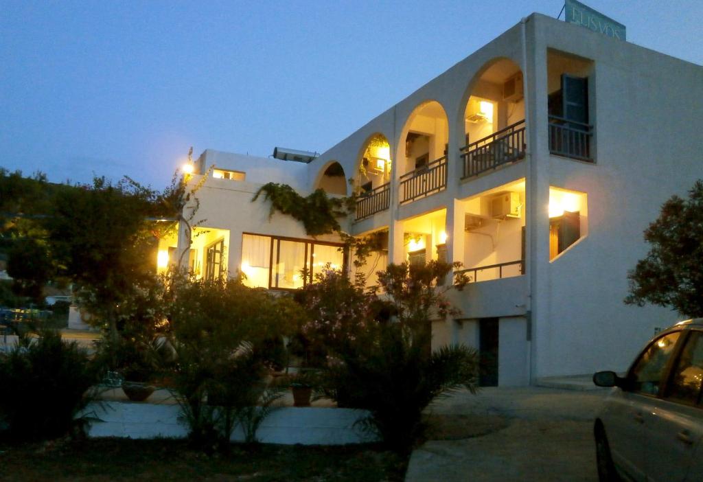 a large white building at night with lights at Hotel Flisvos in Megalochori