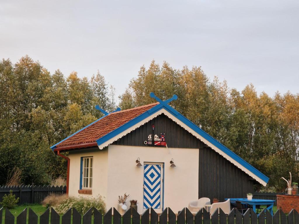 a play house with a roof on top of it at Pieninė in Ventė