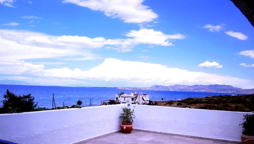 a view of the ocean from the balcony of a house at Hotel Flisvos in Megalochori