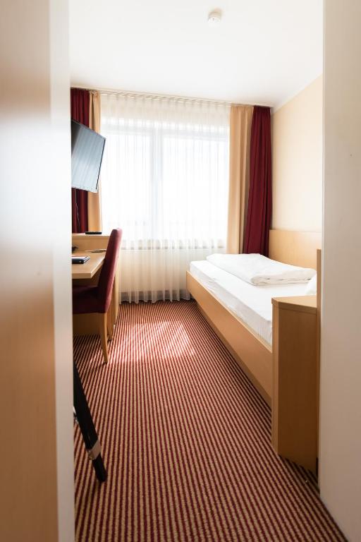Postel nebo postele na pokoji v ubytování Europa Kehl Hotel