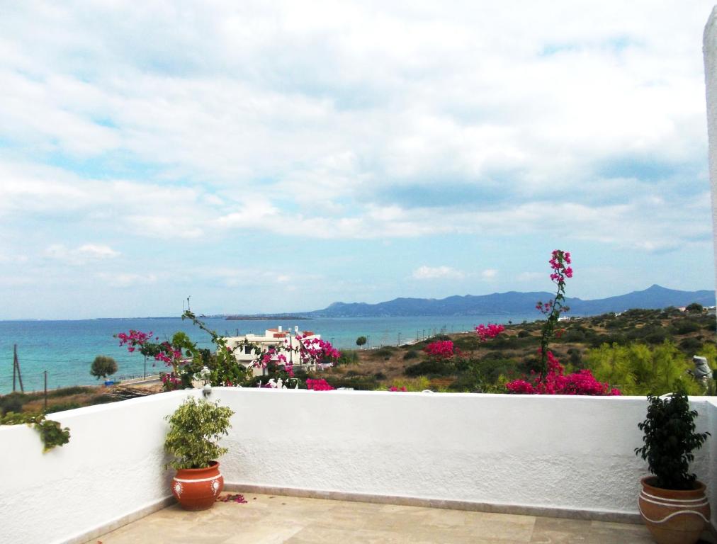 a view of the ocean from the balcony of a house at Hotel Flisvos in Megalochori