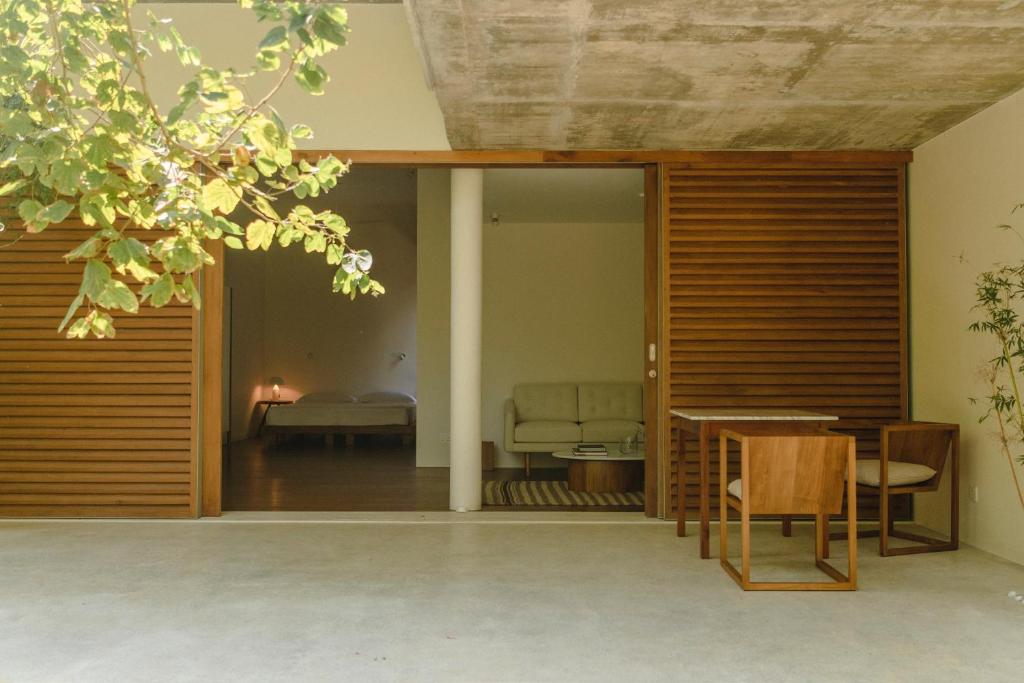 a room with a table and a bed in the background at Kurulu Bay in Ahangama