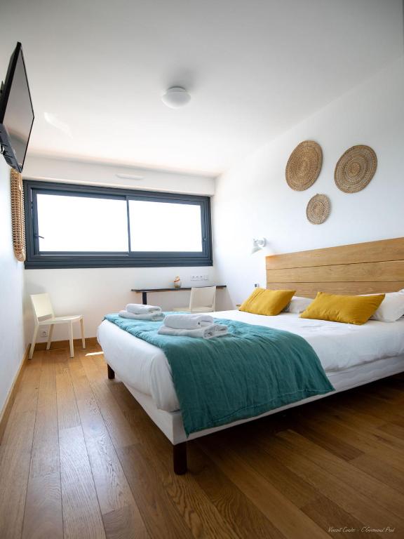 Una cama o camas en una habitación de Logis Hôtels - Le Bellaroc - Hôtel 2 étoiles et Restaurant