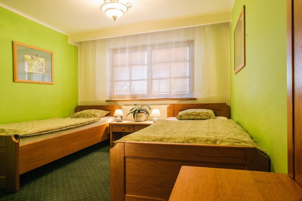 Postel nebo postele na pokoji v ubytování Penzion Lhotka