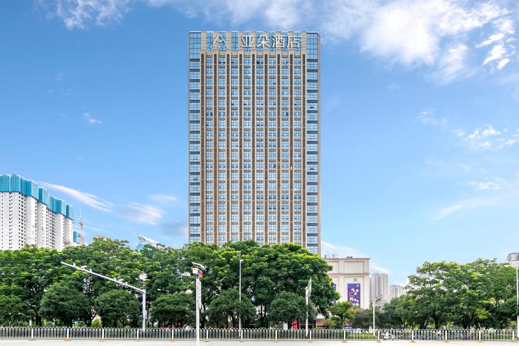 a tall building with a sign on the side of it at Atour Hotel Wuhan Guanshan Avenue Guanggu Software Park in Wuhan