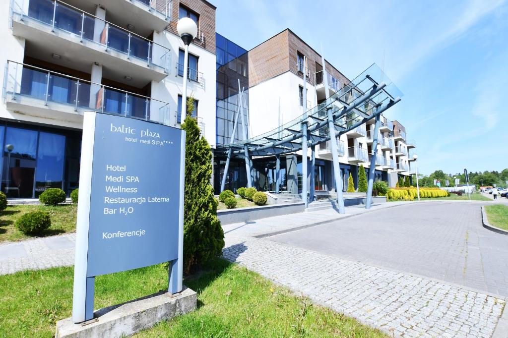 a sign in front of a building at Apartament Baltic Plaza 316 in Kołobrzeg