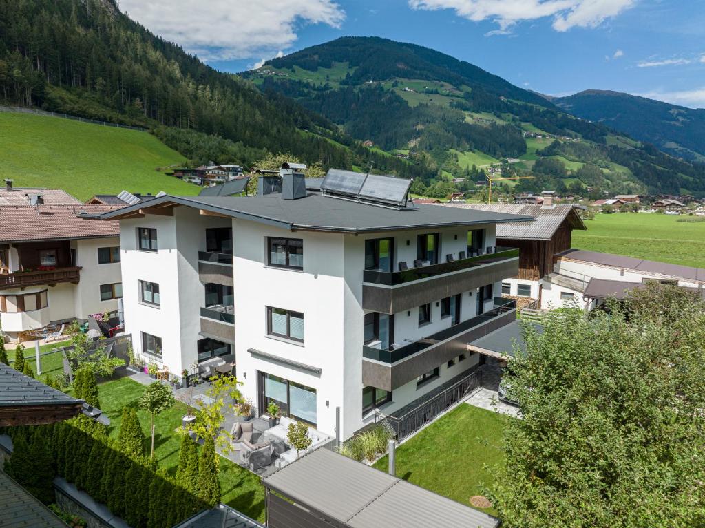 an aerial view of a building with mountains in the background at Apart Alina in Schwendau