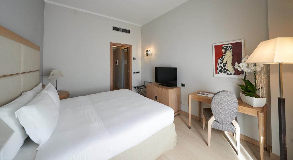 Postel nebo postele na pokoji v ubytování Hotel Astoria