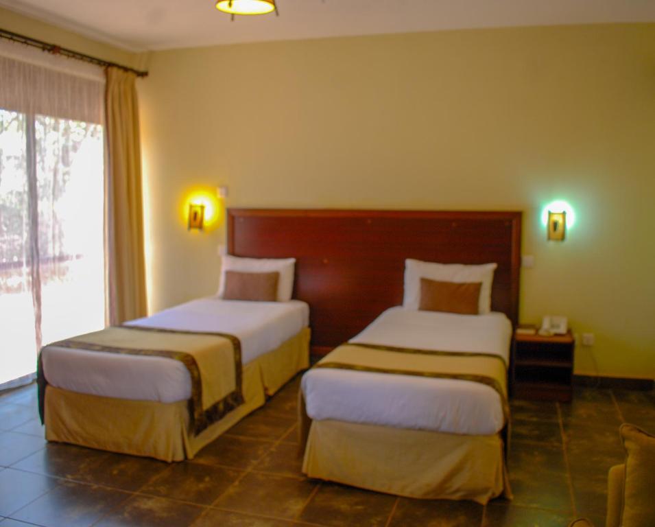 Postel nebo postele na pokoji v ubytování Sagana Getaway Resort