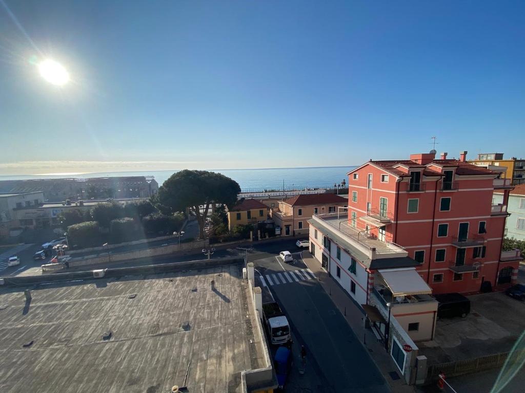 an aerial view of a city with buildings and the ocean at SOLUZIONE CASA Pietra Ligure SEA VIEW in Pietra Ligure