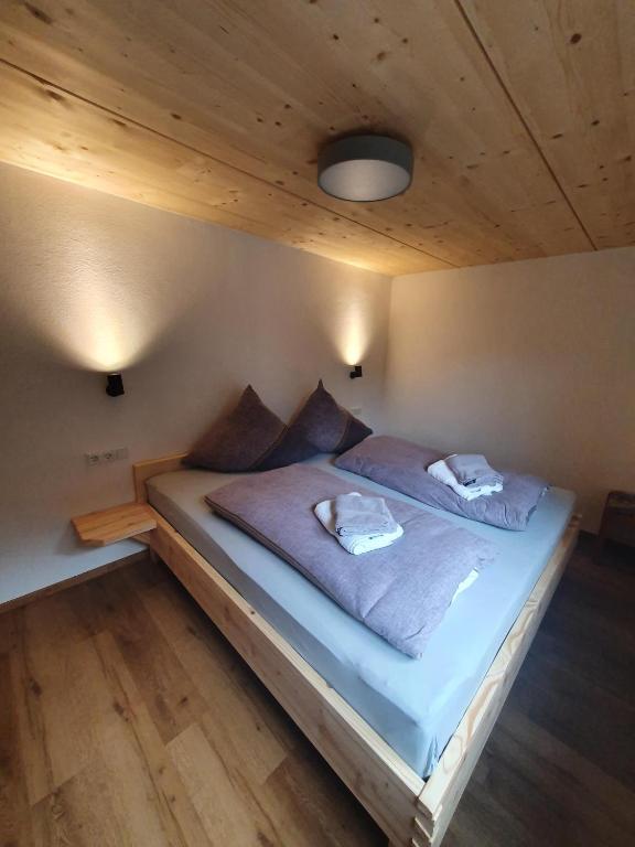 a bedroom with a bed with two pillows on it at FeWo Fritz in Bad Hindelang