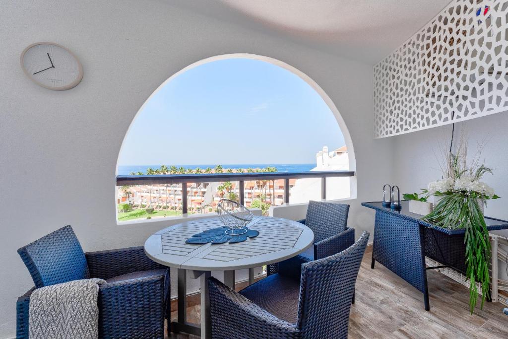 a dining room with a table and chairs and a window at Park Santiago 2 Luxury Studio 8 in Arona