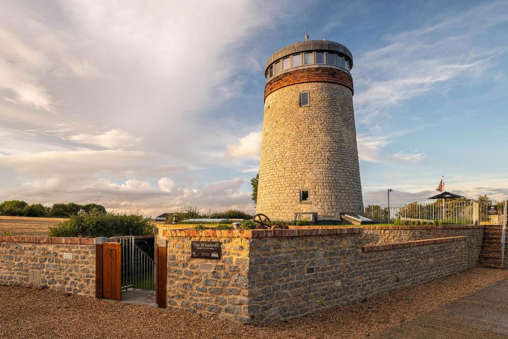 a brick lighthouse sitting on top of a brick wall at The Windmill Blackthorn Hill in Bicester