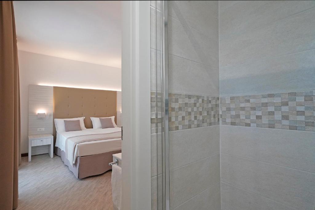 Postel nebo postele na pokoji v ubytování Hotel Strand a frontemare