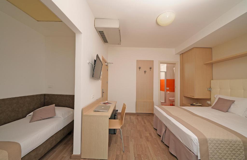 Postel nebo postele na pokoji v ubytování Hotel Strand a frontemare