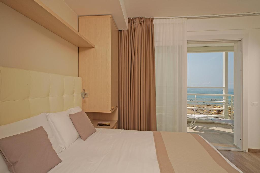 Postel nebo postele na pokoji v ubytování Hotel Strand a frontemare