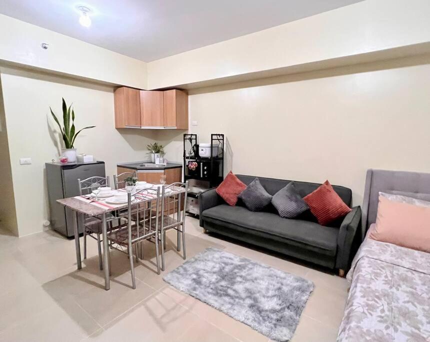 a living room with a couch and a table at Condo Unit near Ayala Serin Mall in Tagaytay