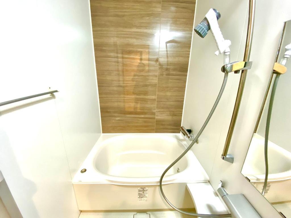 a bathroom with a shower and a toilet at Villa Monica in Nagoya