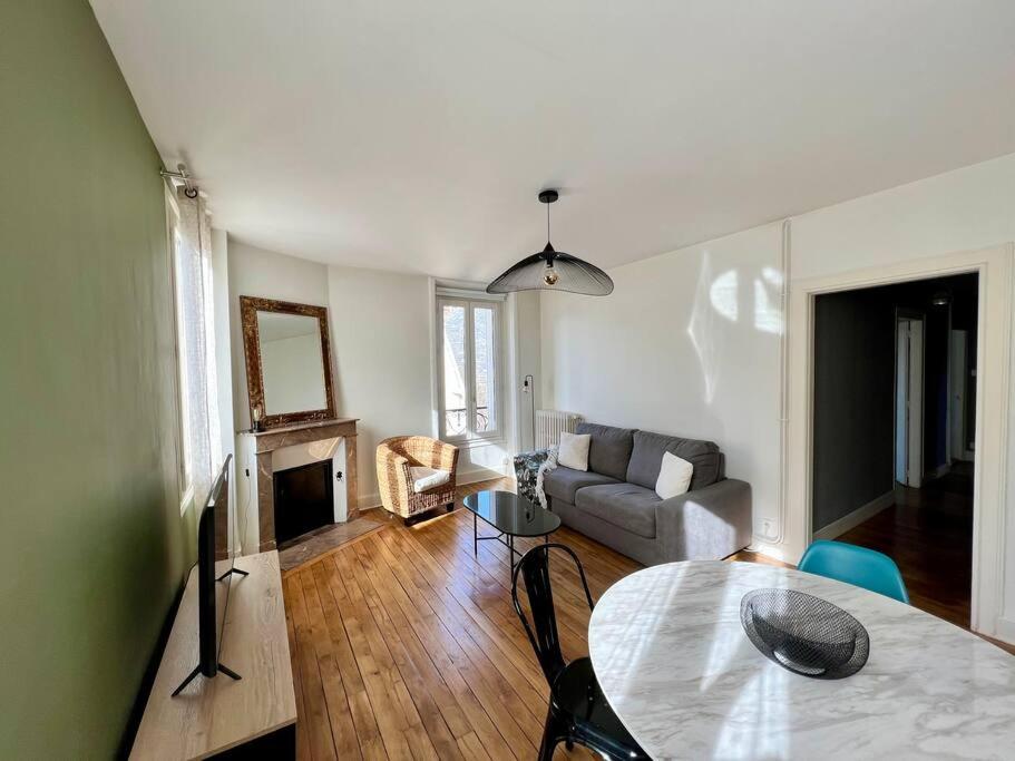een woonkamer met een tafel en een bank bij Casa Gambetta #15 - Sublime T2 Moderne & Design - Brive Coeur de Ville in Brive-la-Gaillarde