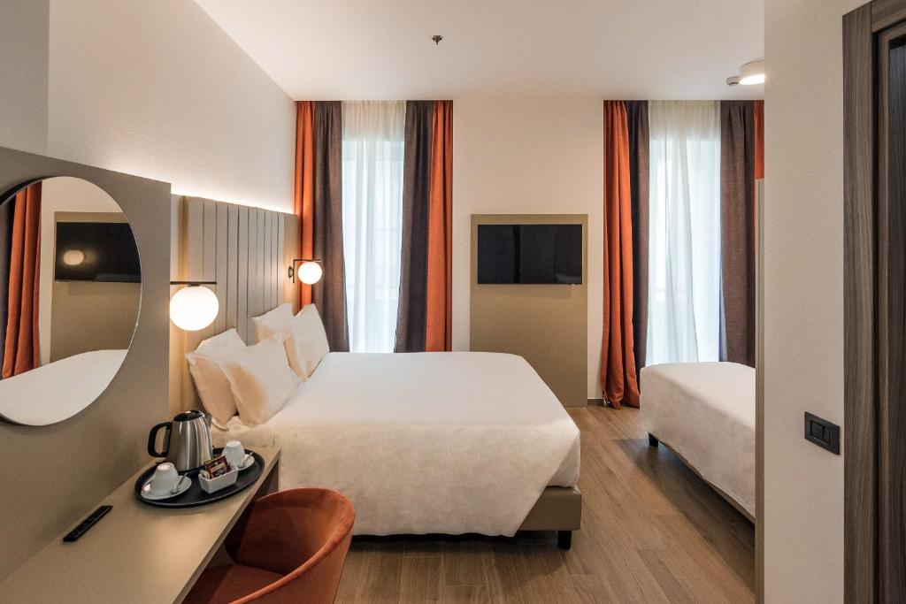Łóżko lub łóżka w pokoju w obiekcie BB Hotels Smarthotel Duomo