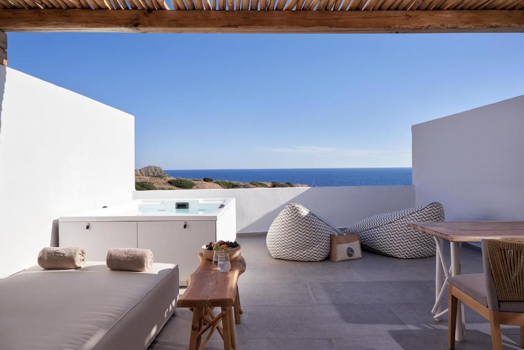a living room with a couch and a table at Armony Suites Milos in Paliochori