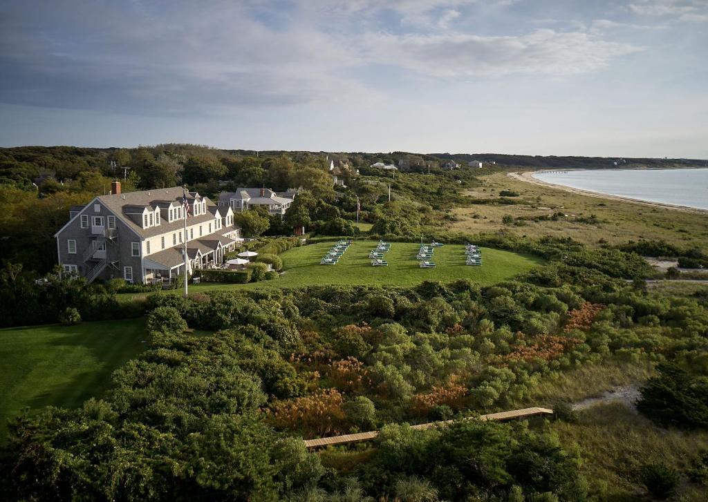 an aerial view of a large house and the beach at The Wauwinet Nantucket in Wauwinet
