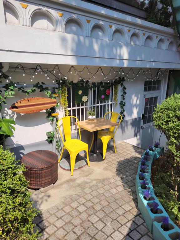 a patio with a table and two chairs and a table and a bench at Newly renovated hidden gem in Seoul