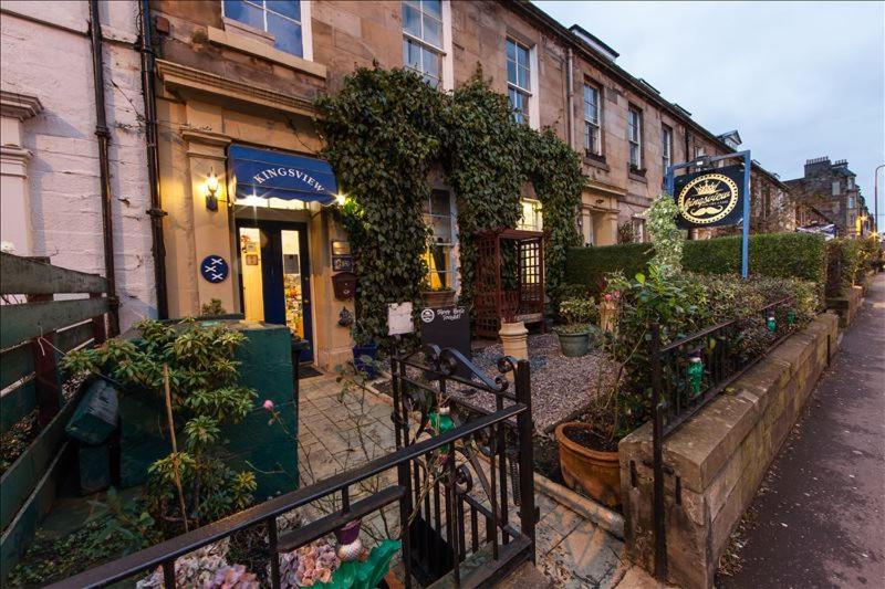 a building with a clock on the side of it at THE KINGSVIEW TOWNHOUSE - Boutique Hostel in Edinburgh