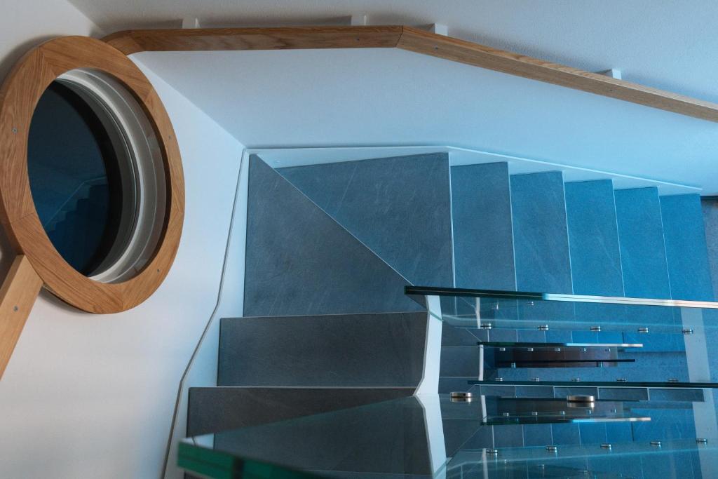 a stairwell with blue glass and a circular window at Colonna 24 Luxury Room in Portovenere near 5 Terre in Portovenere