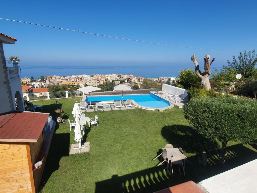 a backyard with a swimming pool and lawnitures at Appartamenti Borgo Panoramico N 4 in Tropea