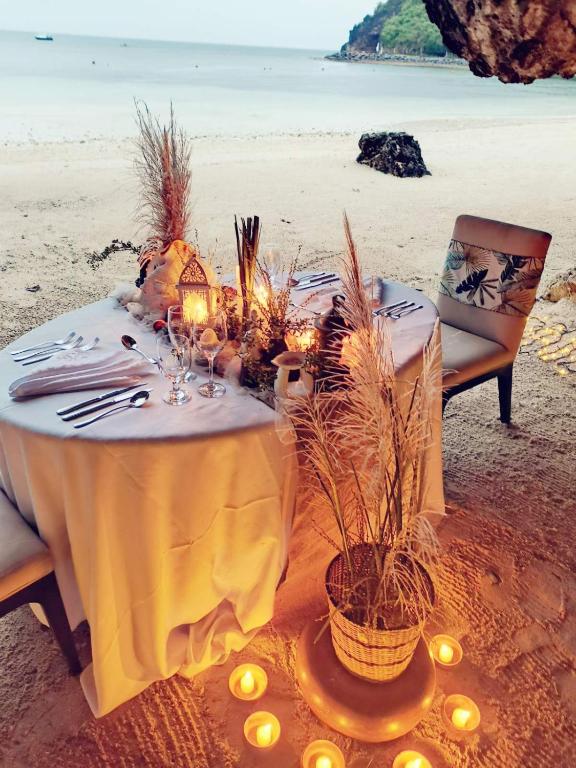 a table on the beach with candles and plants at Fairways and Bluewater Boracay in Boracay
