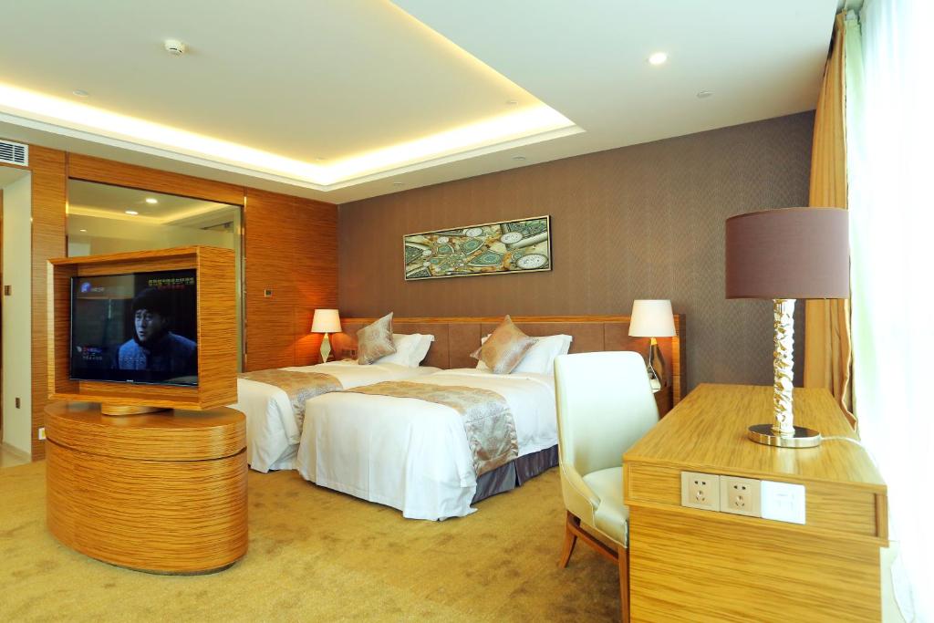 Postel nebo postele na pokoji v ubytování Shenzhen Baoan PLUS Gems Cube Hotel