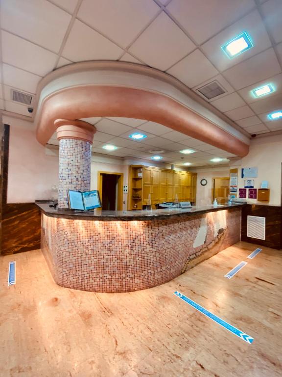 a lobby with a stone counter in a building at Hotel Vent de Mar in Puerto de Sagunto