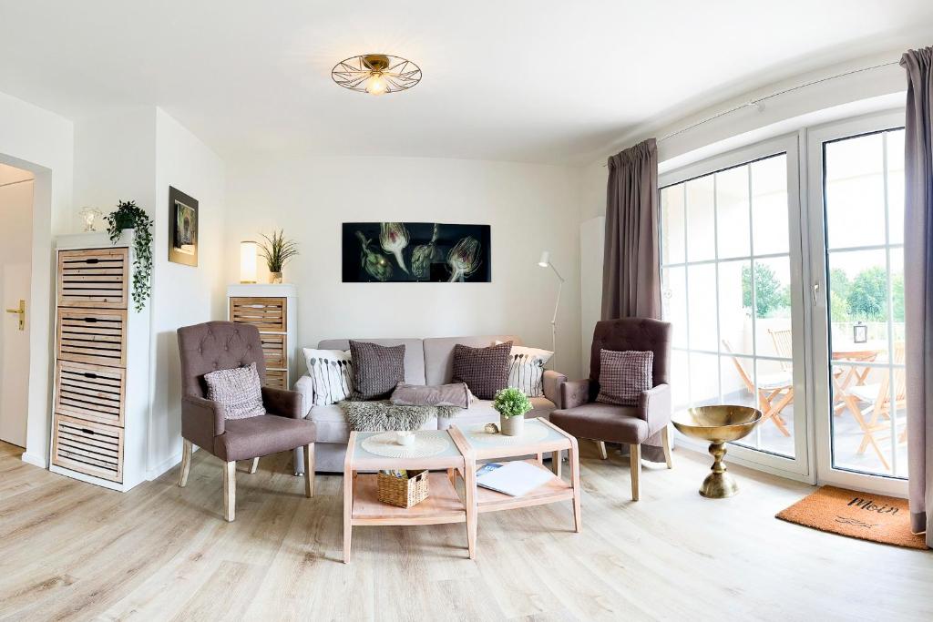 a living room with a couch and chairs and a table at fewo1846 Strandresidenz Wassersleben - OstseeNest - modernes Studioapartment mit Balkon am Strand in Harrislee