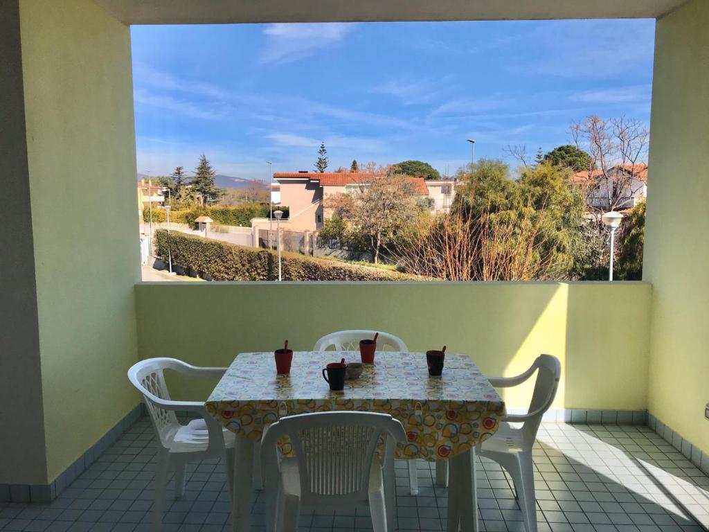 a table and chairs on a balcony with a view at San Rocco residence two bed apartments 5B2 5 in Isca sullo Ionio