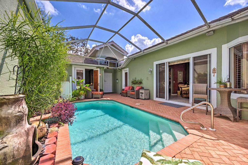 a swimming pool in the backyard of a house at Bonita Springs Condo with Atrium and Pool in Bonita Springs