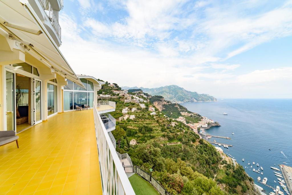 a balcony of a house with a view of the ocean at Grand Hotel Excelsior in Amalfi