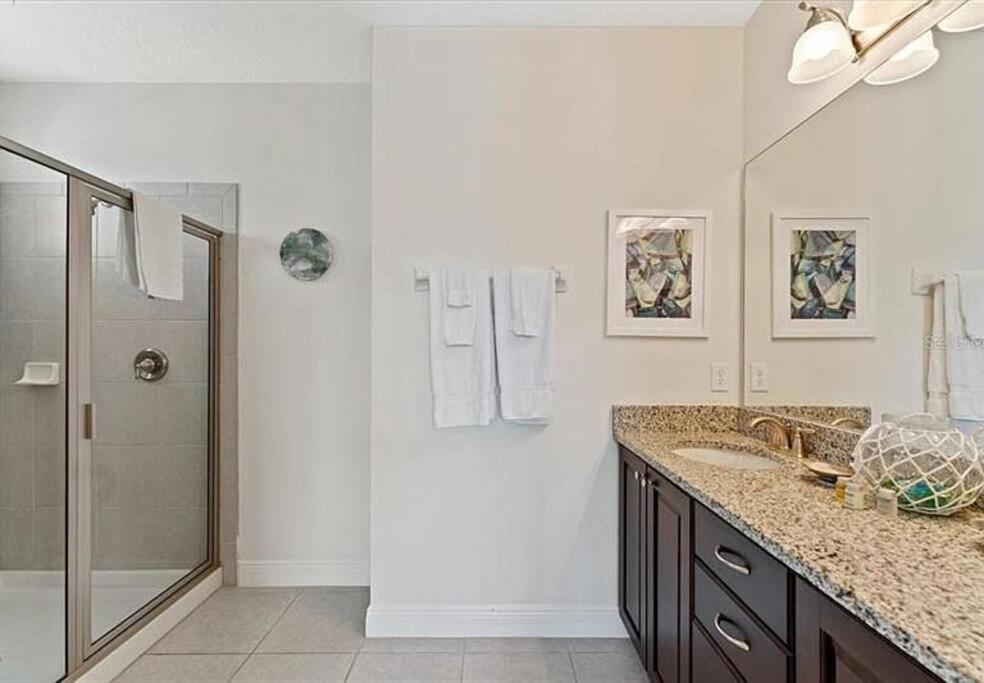 a white bathroom with a shower and a sink at 371 P Luxury Villa- New Listing in Orlando