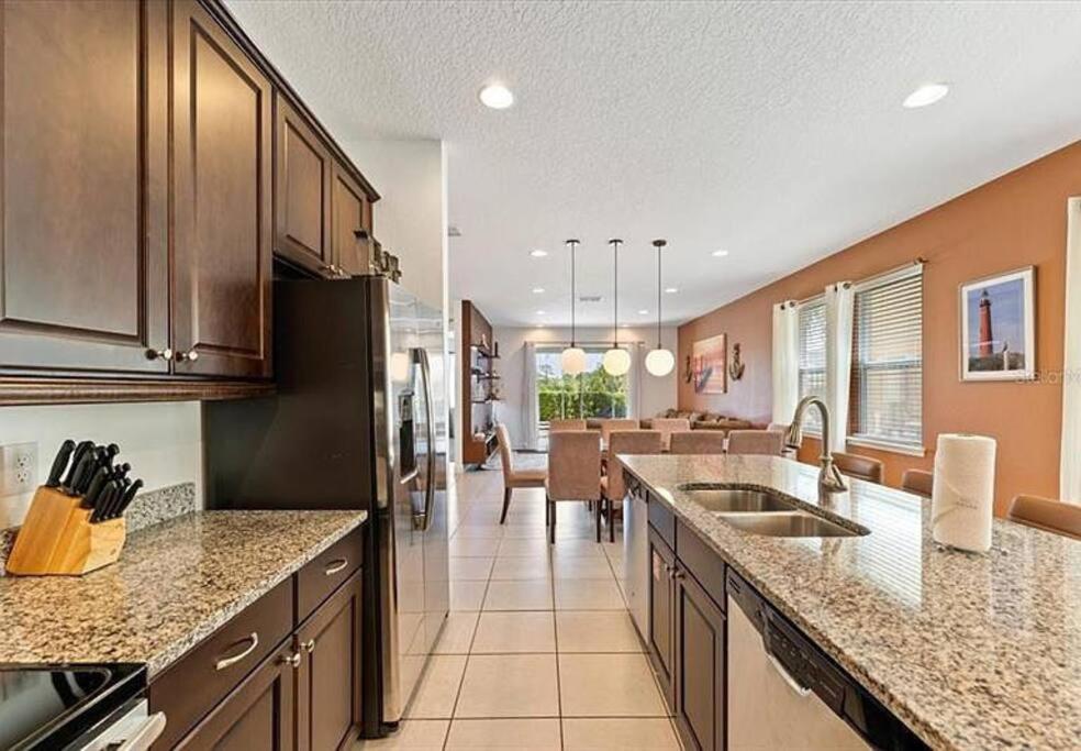 a kitchen with a counter and a dining room at 371 P Luxury Villa- New Listing in Orlando