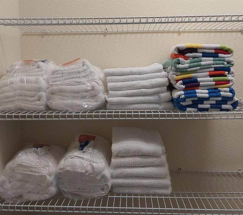 a closet with white towels and a rack of towels at 371 P Luxury Villa- New Listing in Orlando